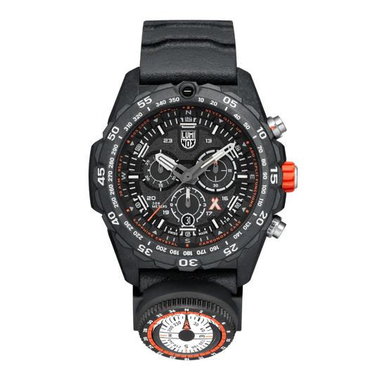 A Luminox Bear Grylls Survival Master Series watch with a black band, black case, and orange crown.