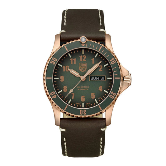 A bronze Luminox Sport Timer watch with a green dial and a brown leather strap, featuring a unidirectional bezel and a buckle closure.